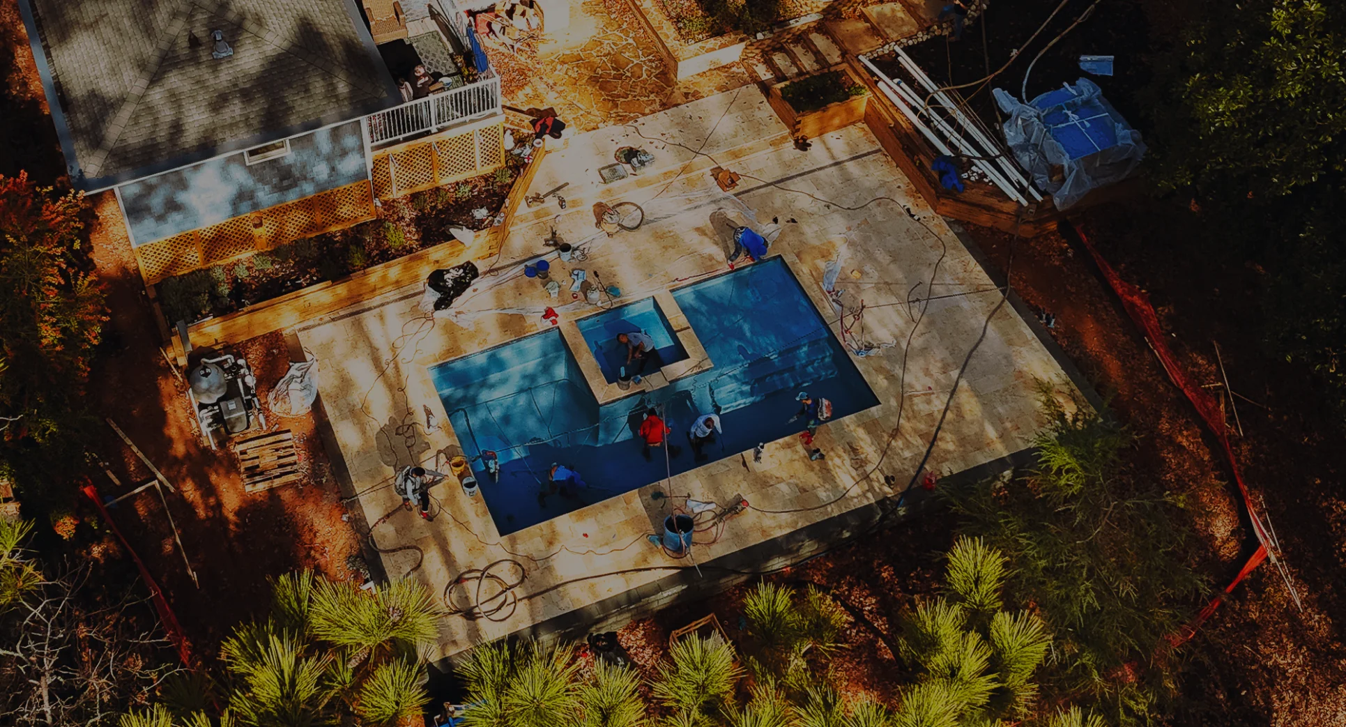 Luxury Vinyl Swimming Pool with silver travertine deck and outdoor furniture